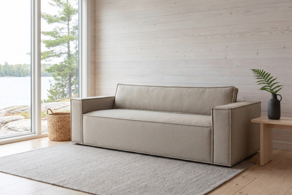 Agerola sofa in Sand in a whitewashed Muskoka cottage living room, the lake through the window