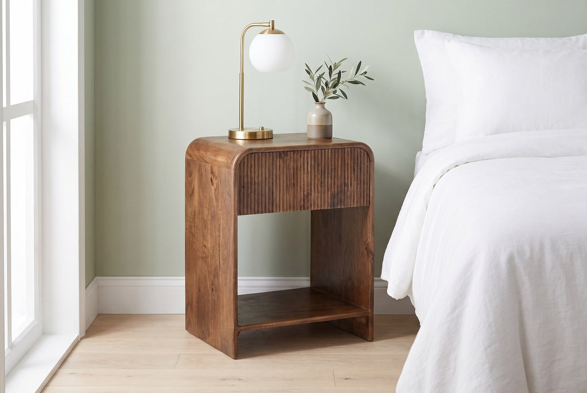 Alberona nightstand in walnut against a pale sage-green wall in a Toronto bedroom in daylight