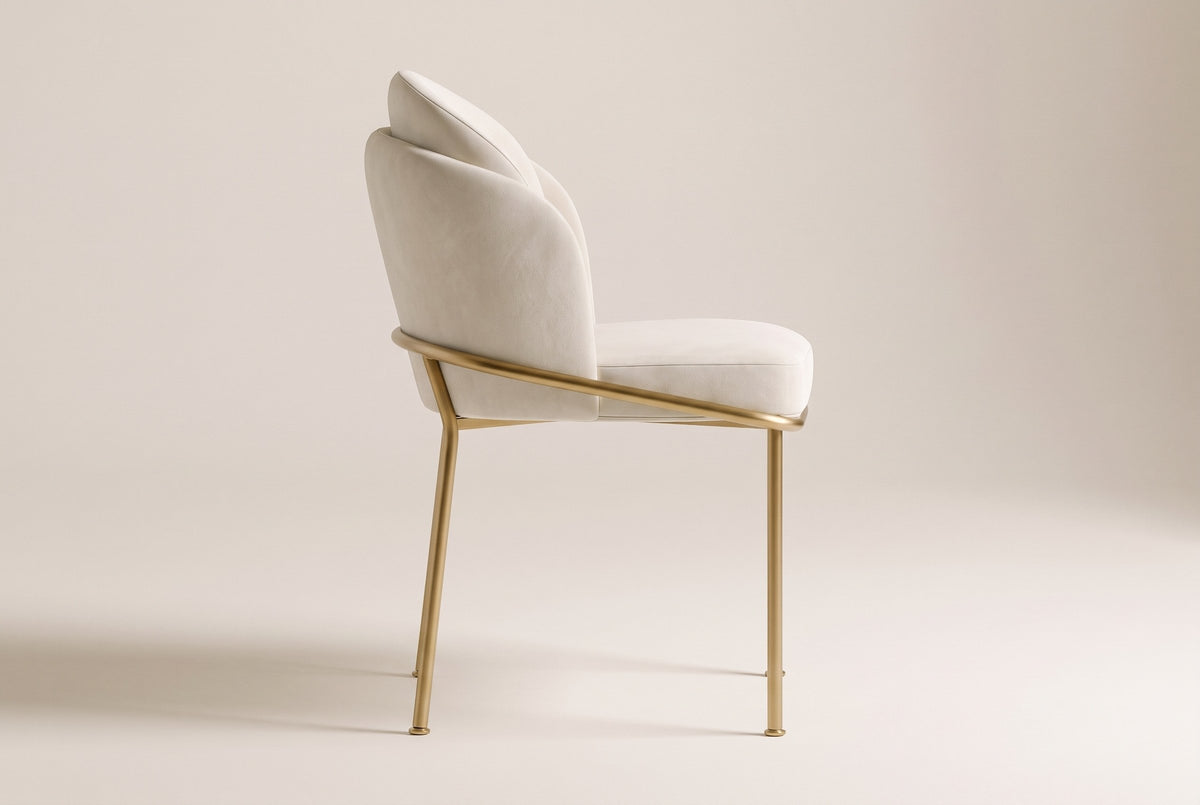 Alexander ivory fabric dining chair with brass legs in side view on an off-white studio backdrop