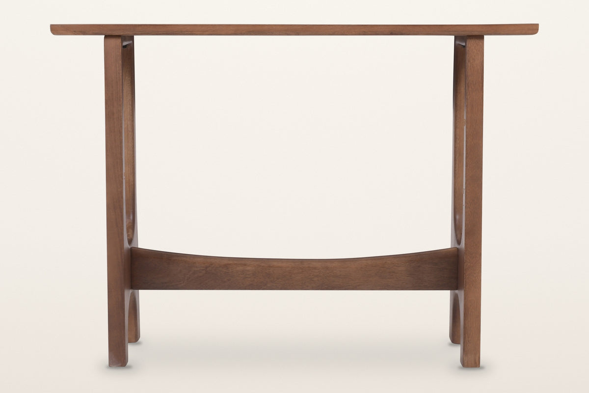 Amelia console table in walnut, straight front view: a thin top on two slotted trestles joined by a curved stretcher