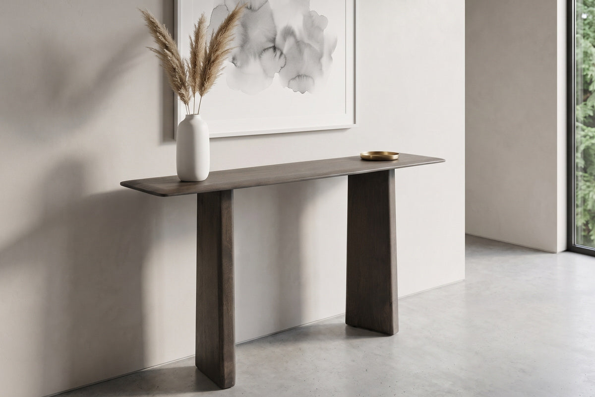 Anghiari console table in mocha in a pale West Coast entry in Vancouver, a white vase of pampas grass and a brass dish on top