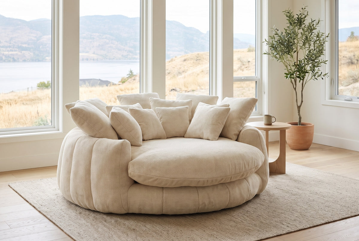 Aosta lounge chair in a Kelowna lake-house living room in the morning, the lake and dry hills beyond the windows