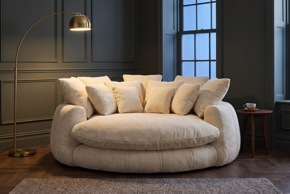 Aosta lounge chair in a Toronto reading corner at dusk under a glowing brass arc floor lamp