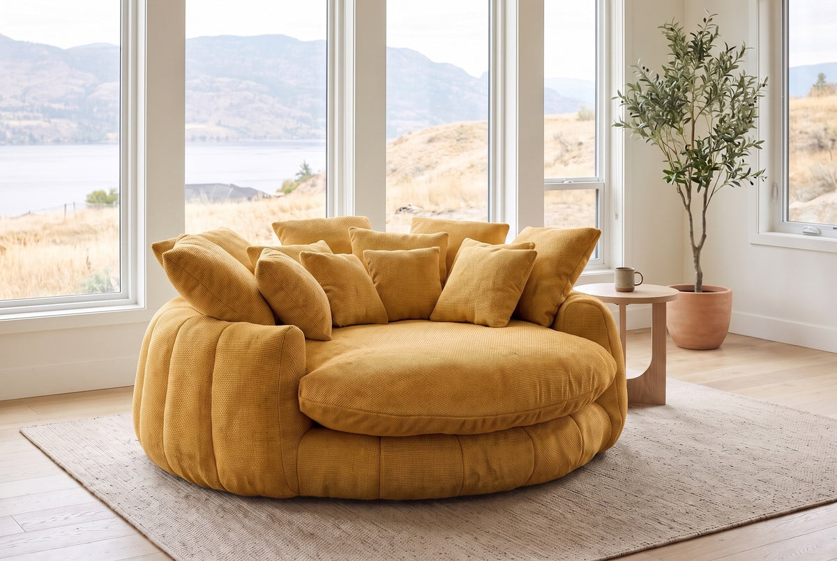 Aosta lounge chair in a Kelowna lake-house living room in the morning, the lake and dry hills beyond the windows (Yellow)