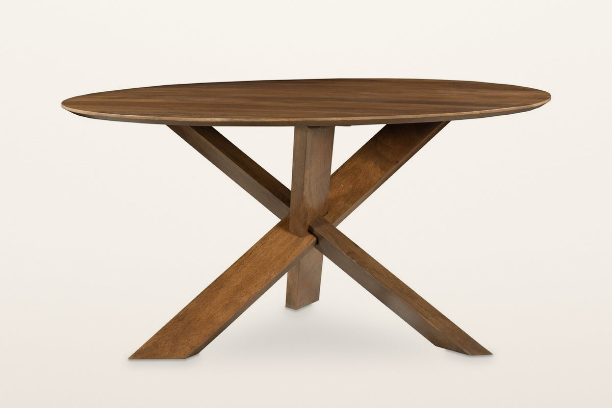 Apecchio dining table in walnut and teak, front view on a warm white studio backdrop: the three legs crossing in one knot