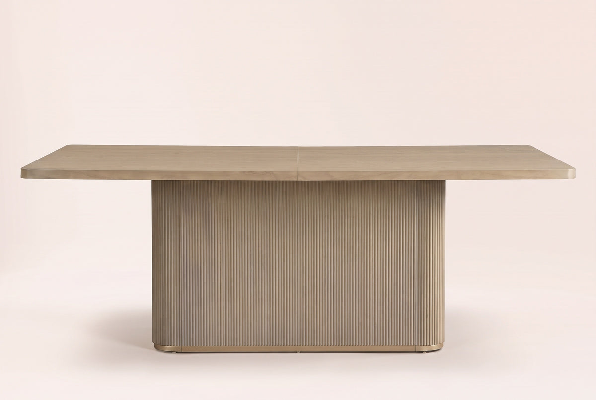 Aquileia dining table in Natural, straight front view: one fluted pedestal with rounded corners