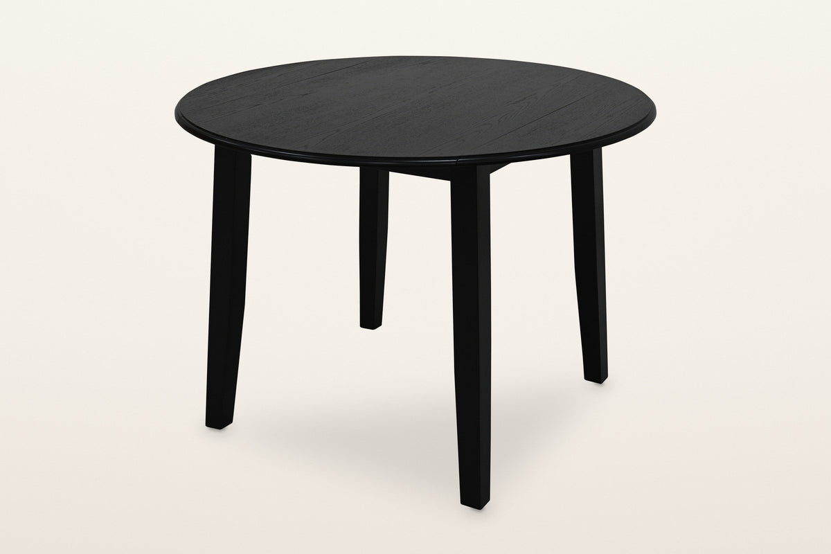 Arden round drop-leaf dining table in Black, both leaves up, three-quarter view on a warm white studio backdrop