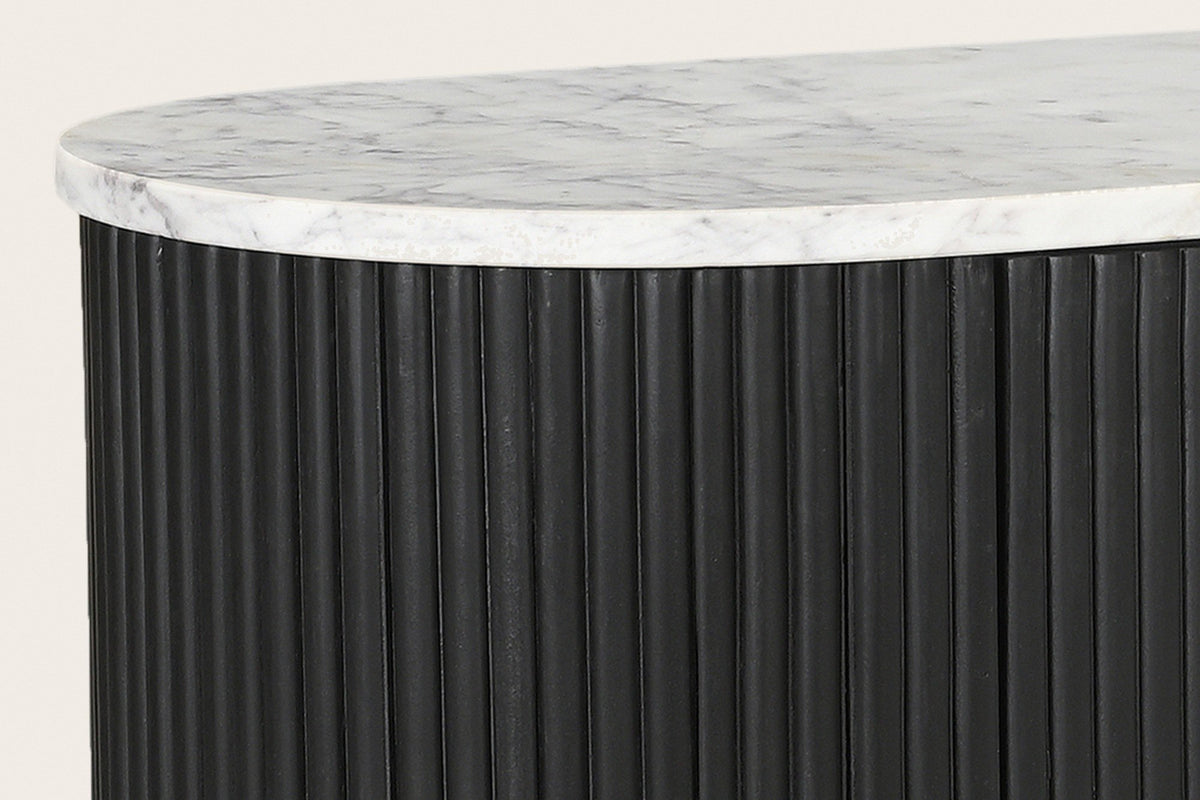 Close-up of the Arpino white marble top over the rounded, reeded end in black