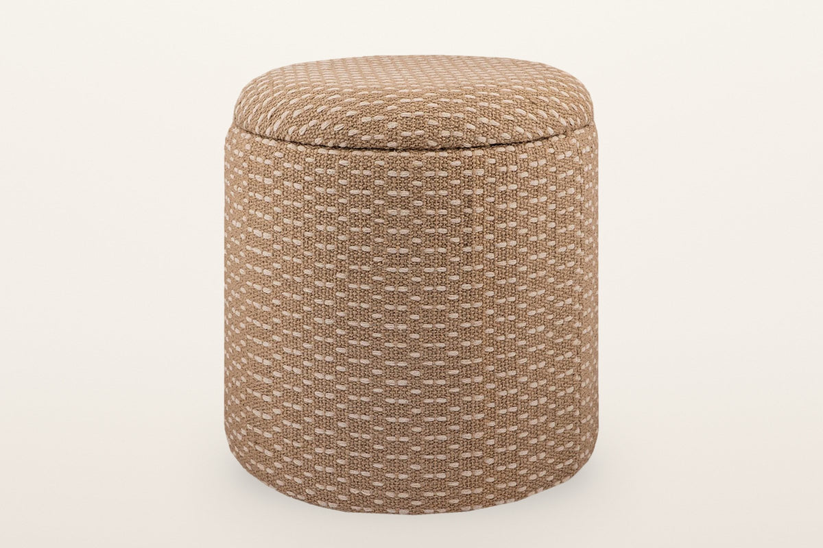 Arvier round storage pouf in Camel, three-quarter view on a warm white studio backdrop: a jute and cotton weave drum with a padded lid