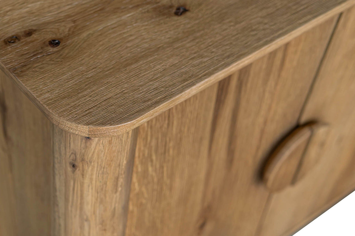 Close-up of a rounded corner of the Atzara top in Natural, with knots in the oak grain