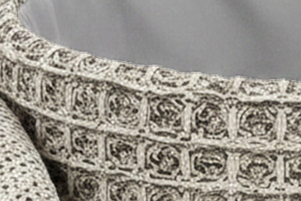 Inside the Balme pouf in Charcoal: the rolled knit rim and the light grey fabric lining