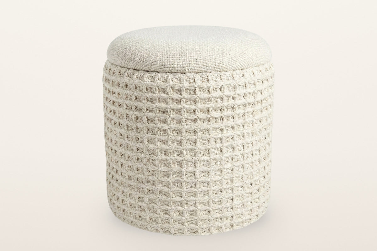 Balme round storage pouf in Ivory on a warm white studio backdrop: a square waffle-knit drum with a domed knitted lid
