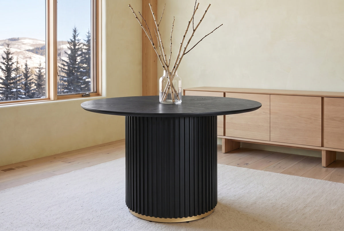Bardolino round table in black in a foothills dining room with tall windows