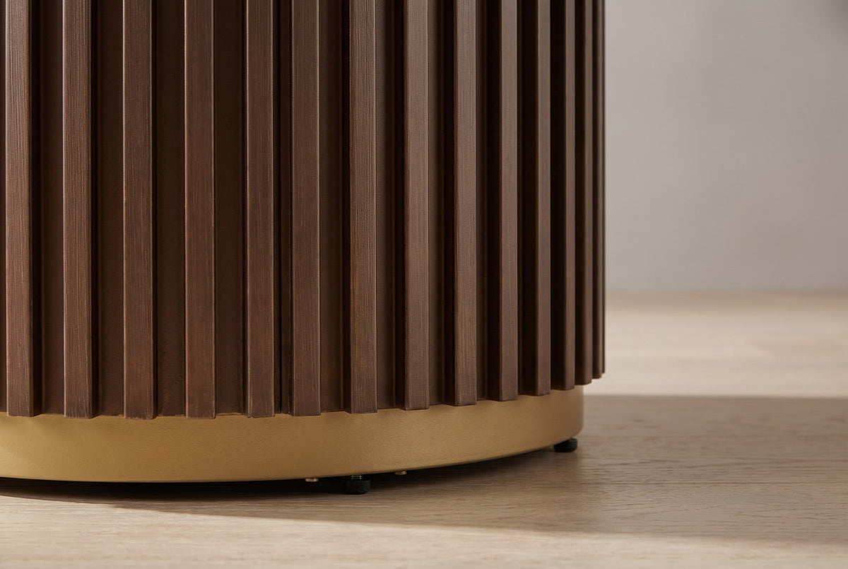 Close-up of the fluted drum base: fine vertical slats stepping onto a gold-finished metal ring with small black feet