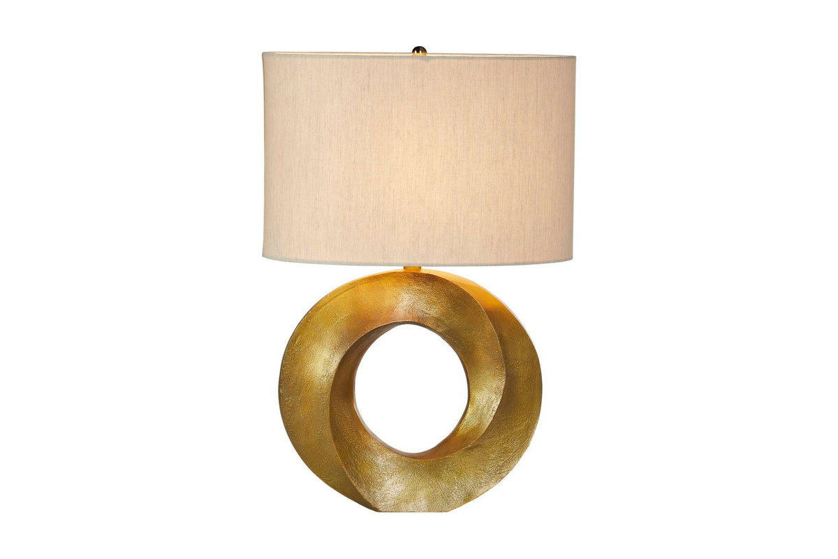 Bastien table lamp switched on, with light glowing through the linen shade