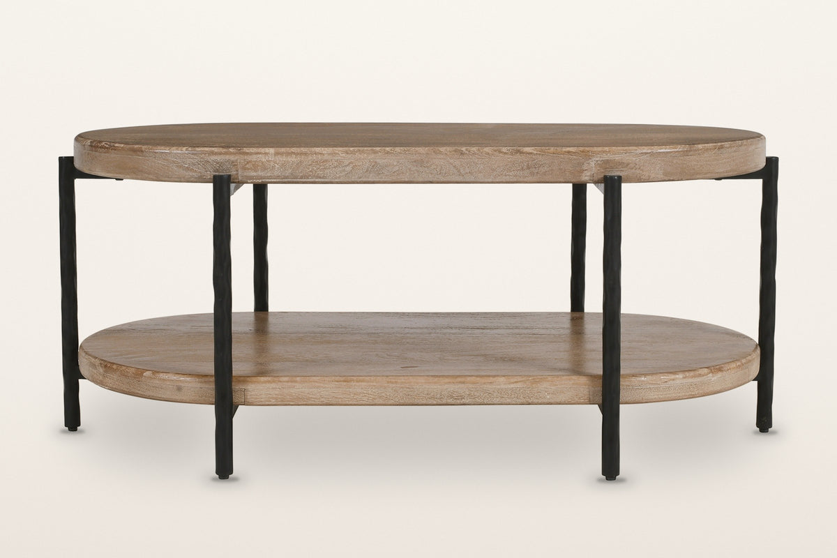 Bellano coffee table from the front: two oval tiers of solid mango wood on six hand-hammered black iron rods