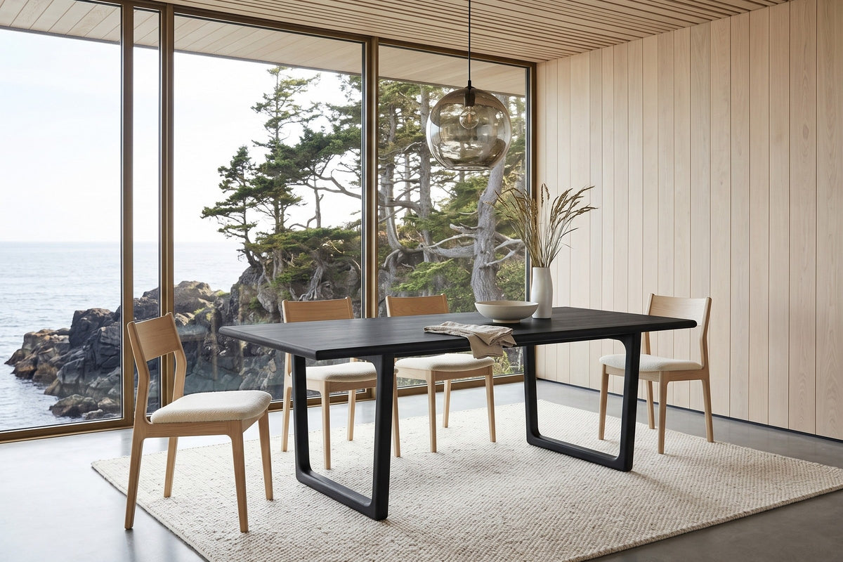 Bernalda dining table in Black in a Ucluelet cliff-top house, with white-oak panelling