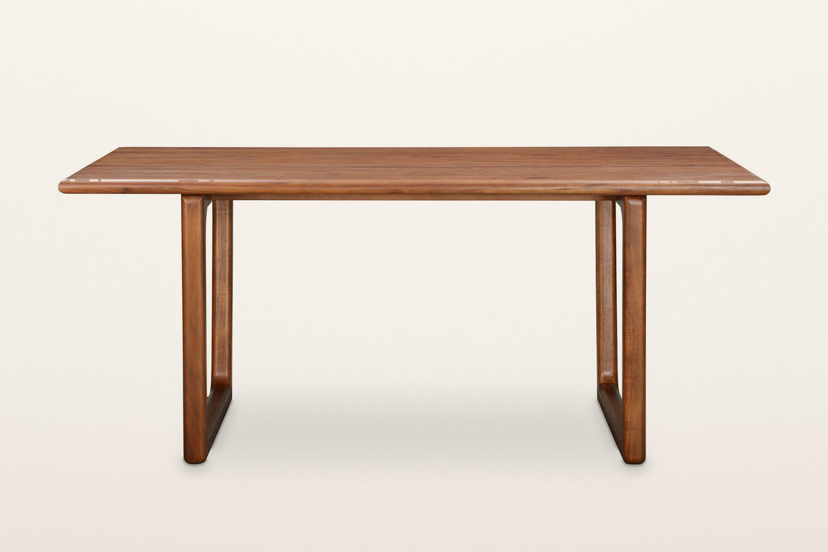 Bernalda dining table in Honey Brown, front view on a warm white studio backdrop: two sled frames set in from the ends