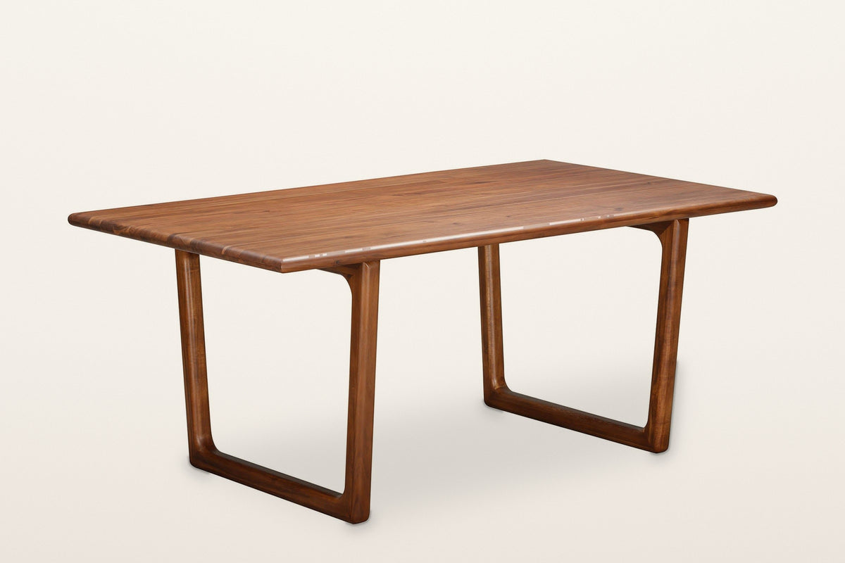 Bernalda sled base dining table in Honey Brown, three-quarter view on a warm white studio backdrop