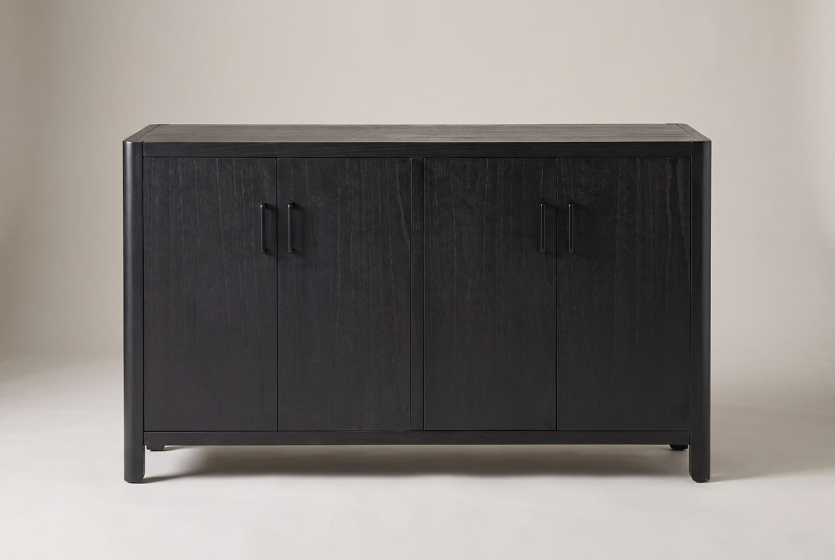 Bibbiena sideboard in black, straight front view: four doors in two pairs, four slim black pulls, rounded corner posts