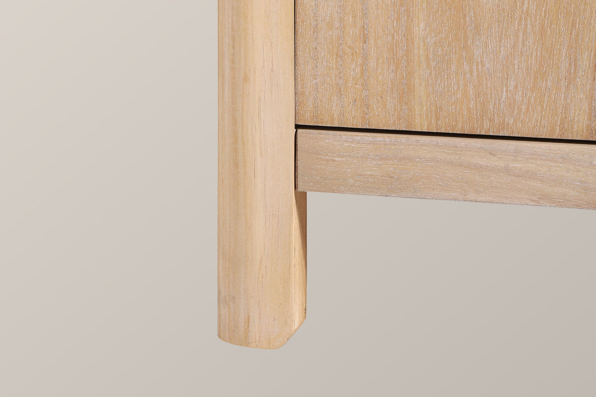 Close-up of a rounded natural solid pine corner post becoming a short leg under the bottom rail
