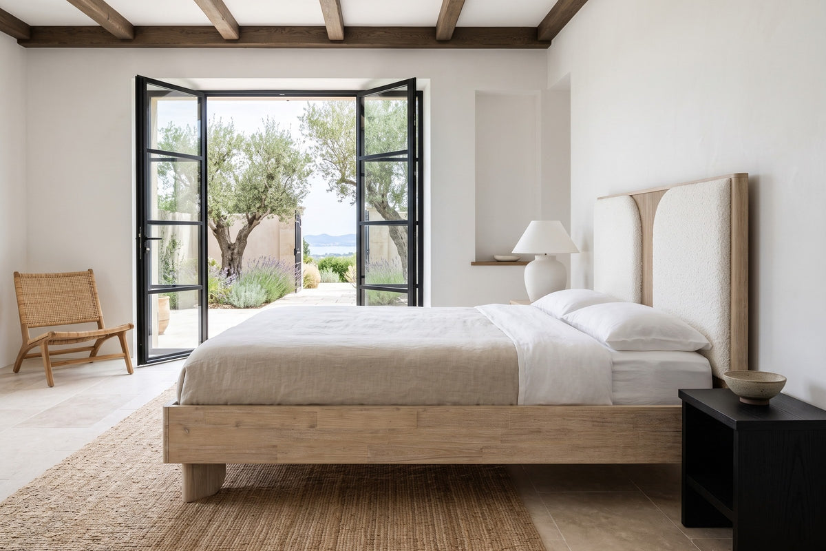 Side view of the Bienno bed in a bedroom in a Saint-Tropez hillside villa, with white plaster