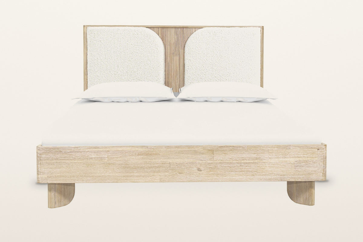Bienno bed in Sand Wash acacia, front view from the foot on a warm white studio backdrop: the box rail on two flat paddle fee
