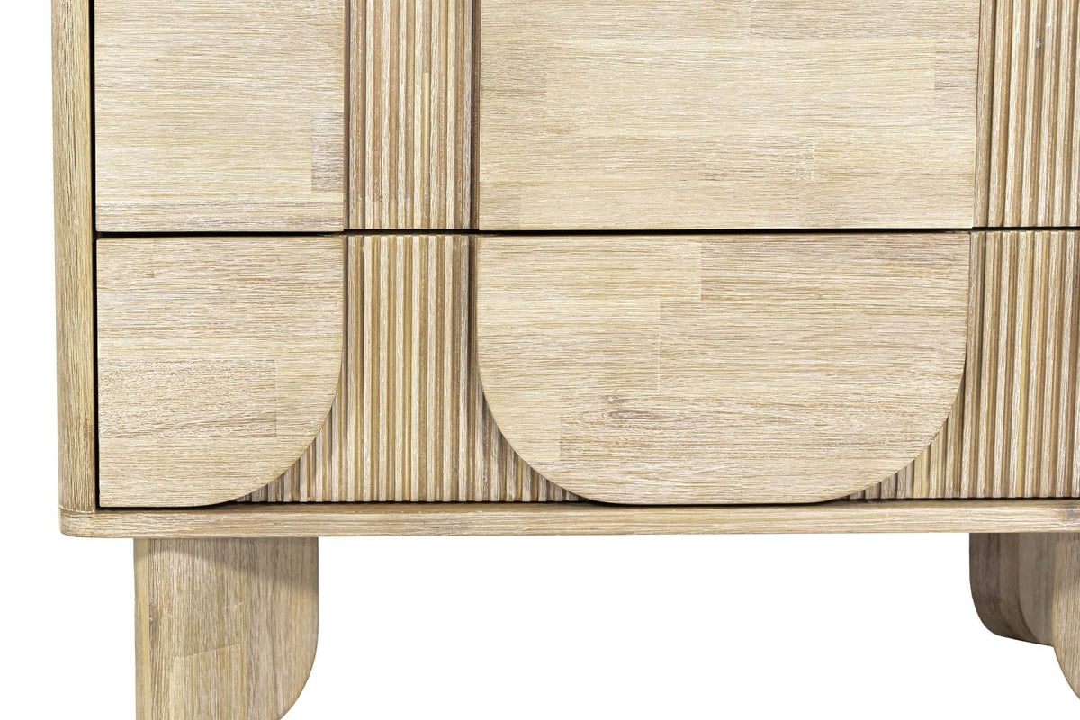 Close-up of the lower front of the Bienno chest in Sand Wash: the rounded bottoms of the pill panels, the fluted strips
