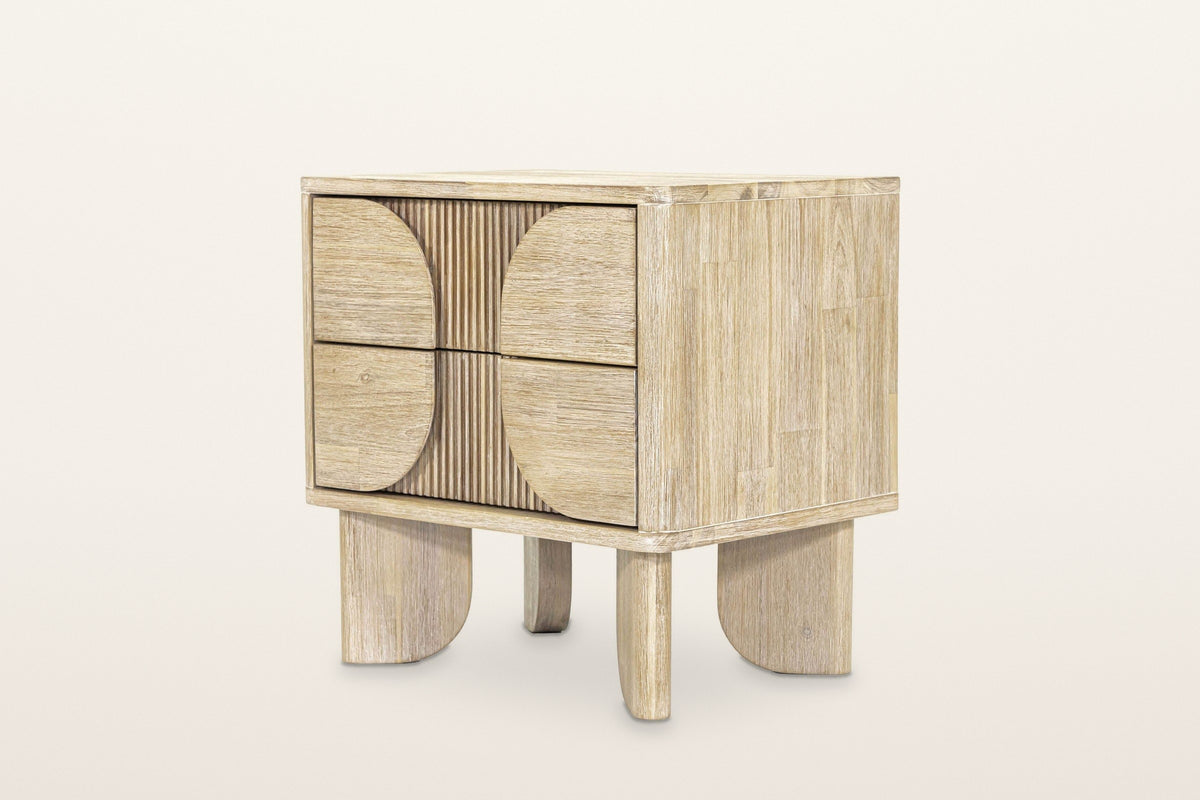 Bienno nightstand in Sand Wash acacia, three-quarter view on a warm white studio backdrop: two drawers with half-round panels