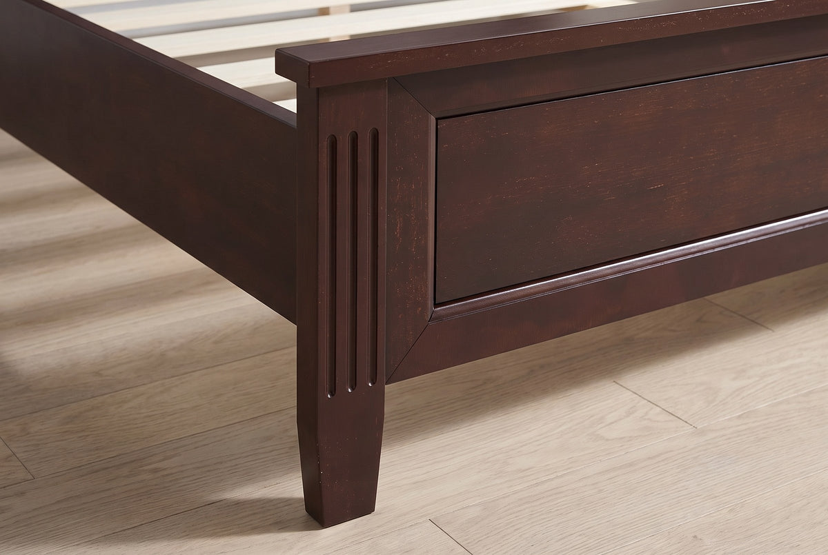 Close-up of the Bolsena footboard corner: a fluted post, the framed panel and a tapered square leg