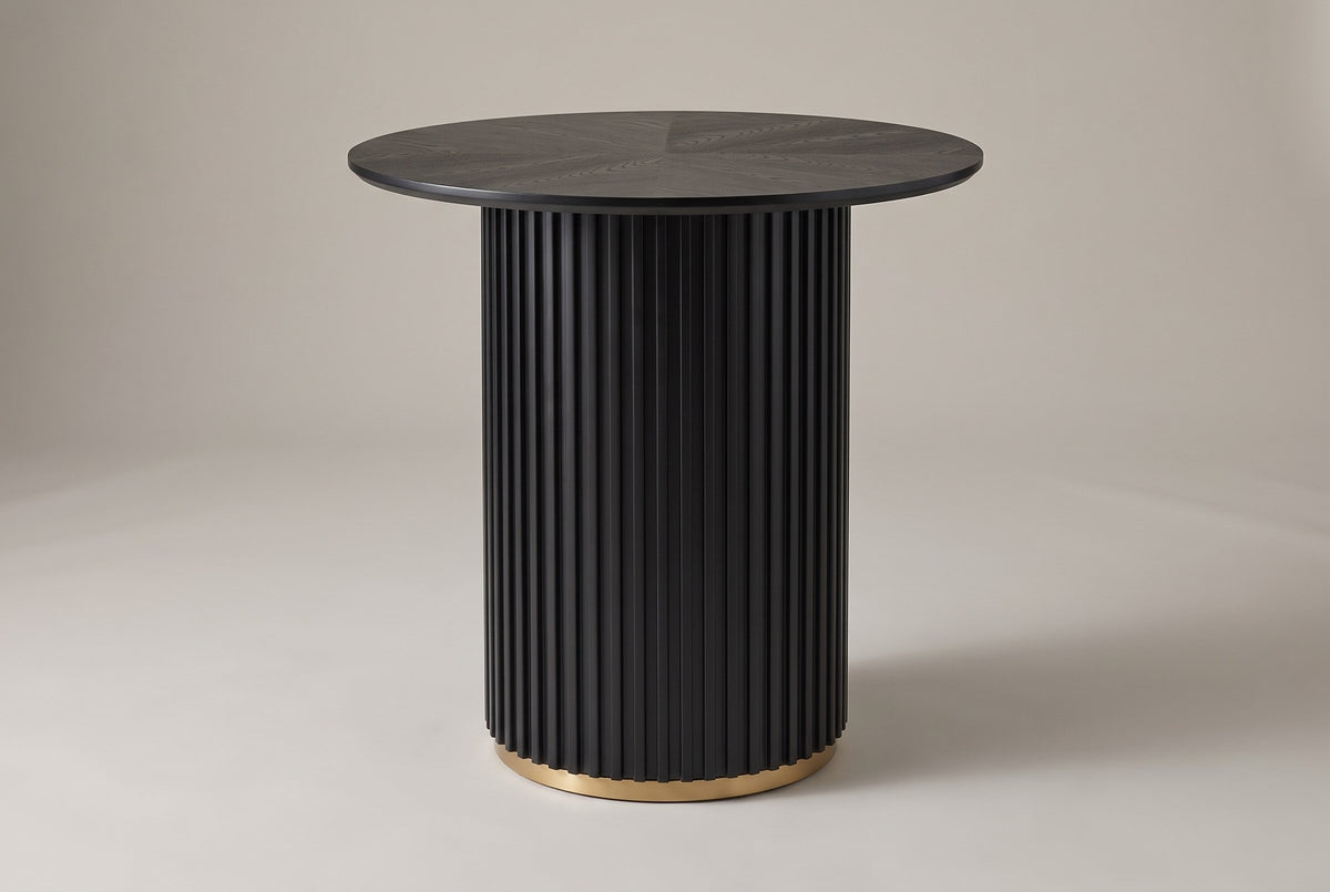 Bolzano round counter height table in black, three-quarter view on a warm grey studio backdrop