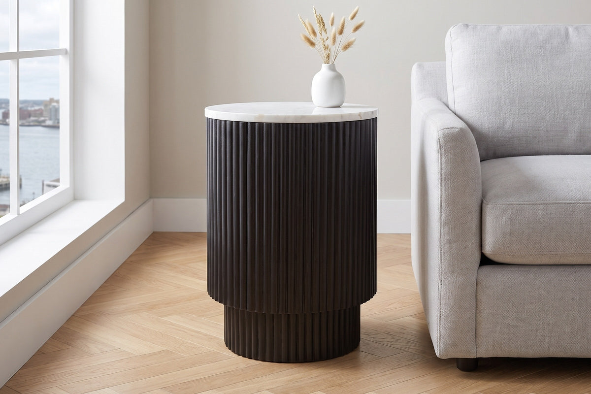 Bomarzo side table in black beside a pale grey linen sofa in a bright Halifax living room