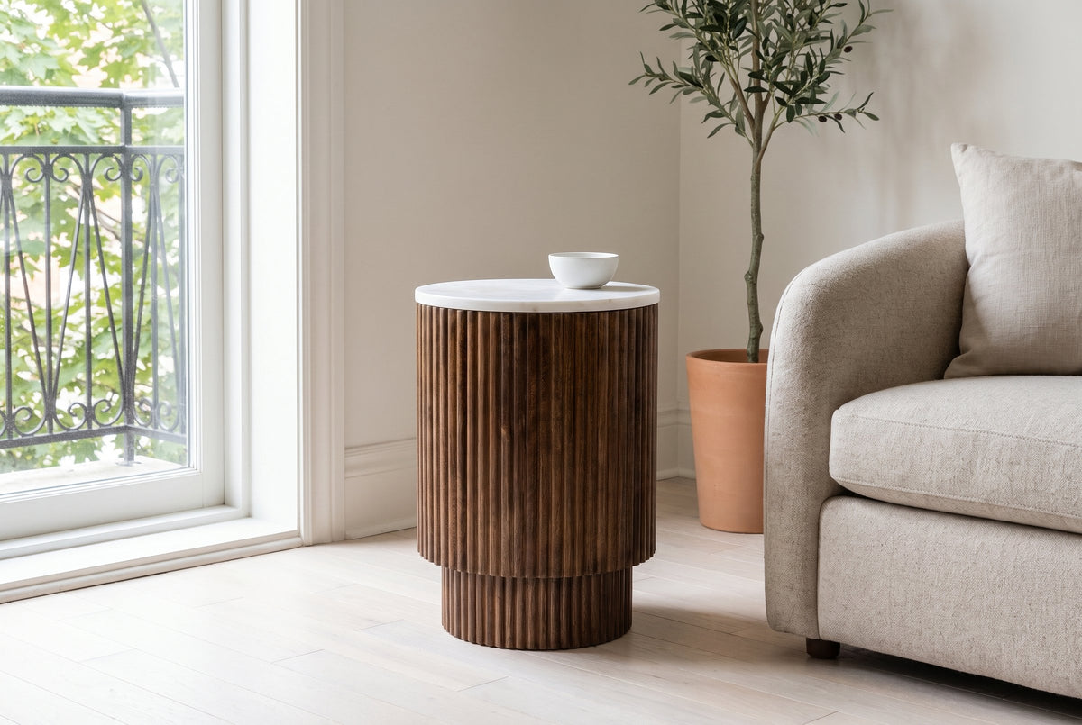 Bomarzo side table in walnut beside an oatmeal sofa in a Montreal living room