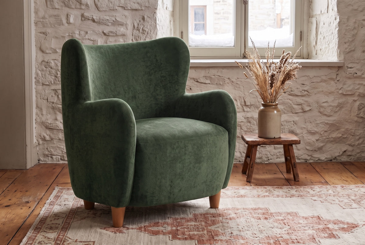 Bormio chair against an old limestone wall with snow outside the window, on wide pine floorboards (Olive Green)