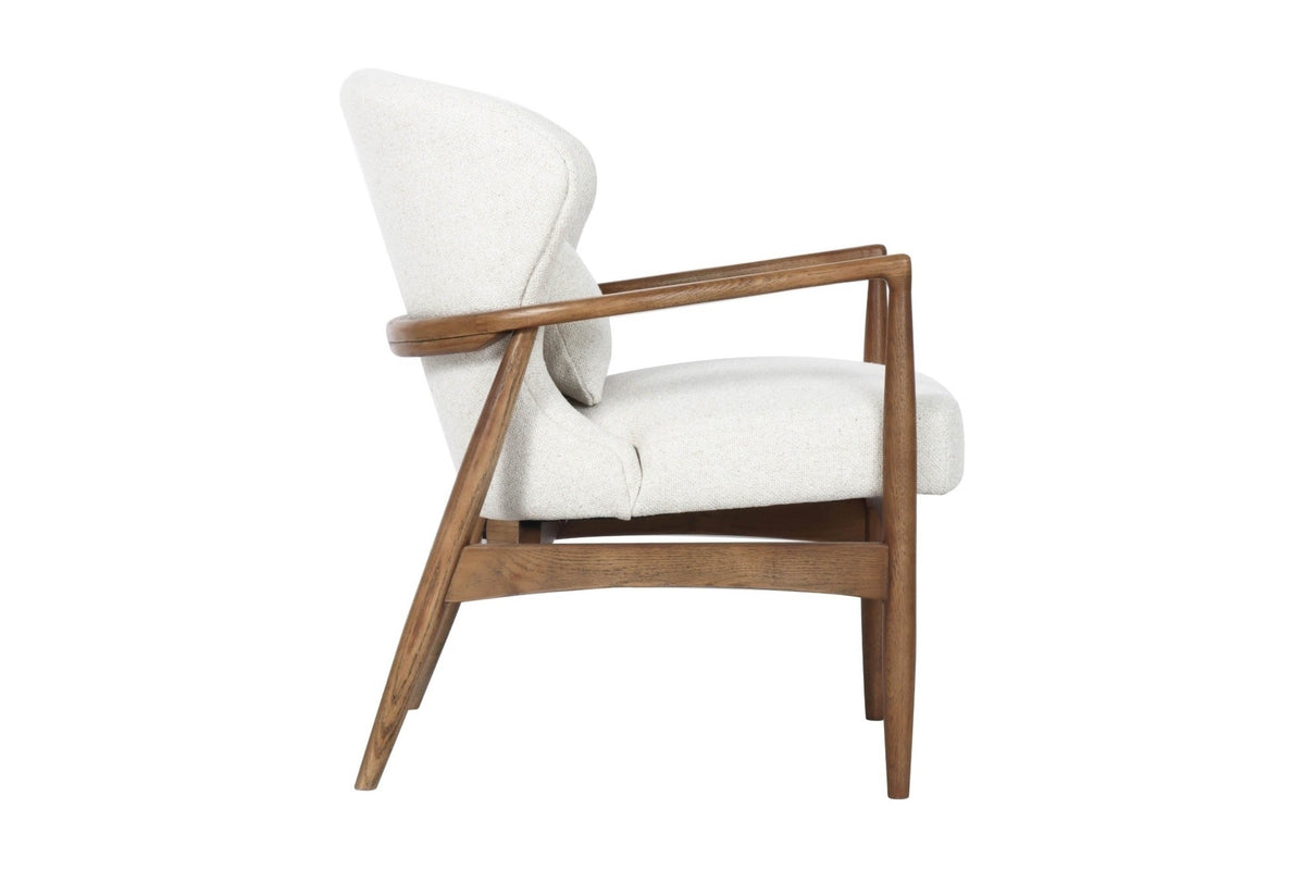 Briar accent chair in Snow, side view of the curved back and ash frame