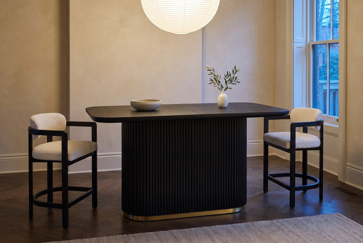 Brugnato counter table in a limewashed Toronto townhouse kitchen at dusk, two counter stools at the ends