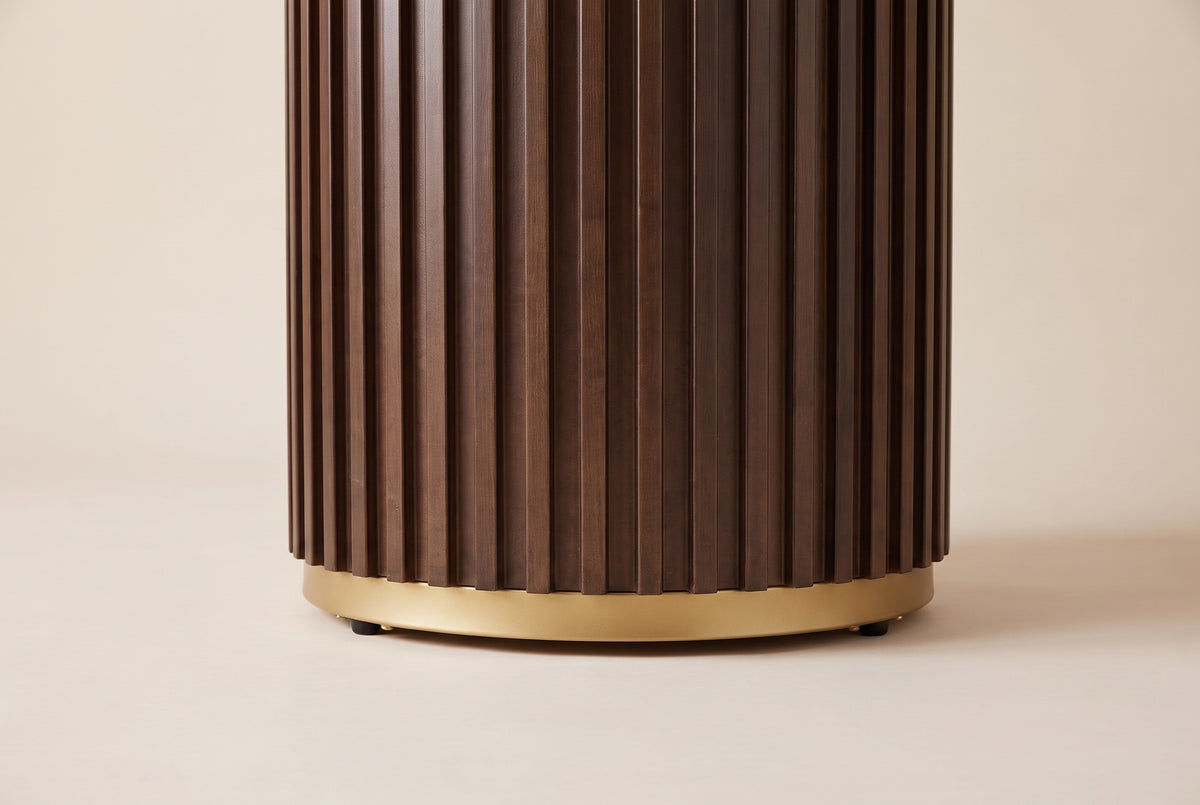 Close-up of the base: tall walnut fluted slats stepping down onto a slim gold-finish ring with small black feet
