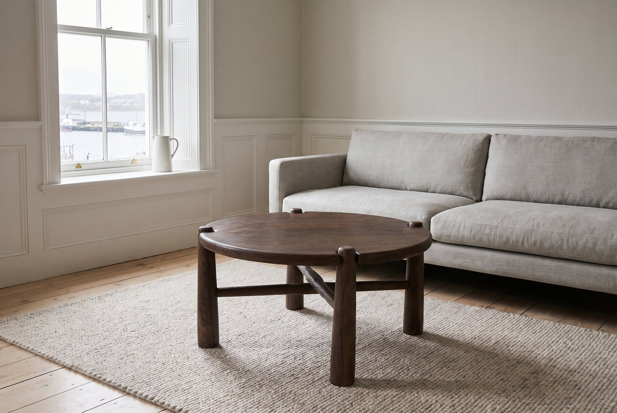 Buonconvento coffee table in dark walnut on an oatmeal wool rug in front of a light grey linen sofa in a Halifax row-house li