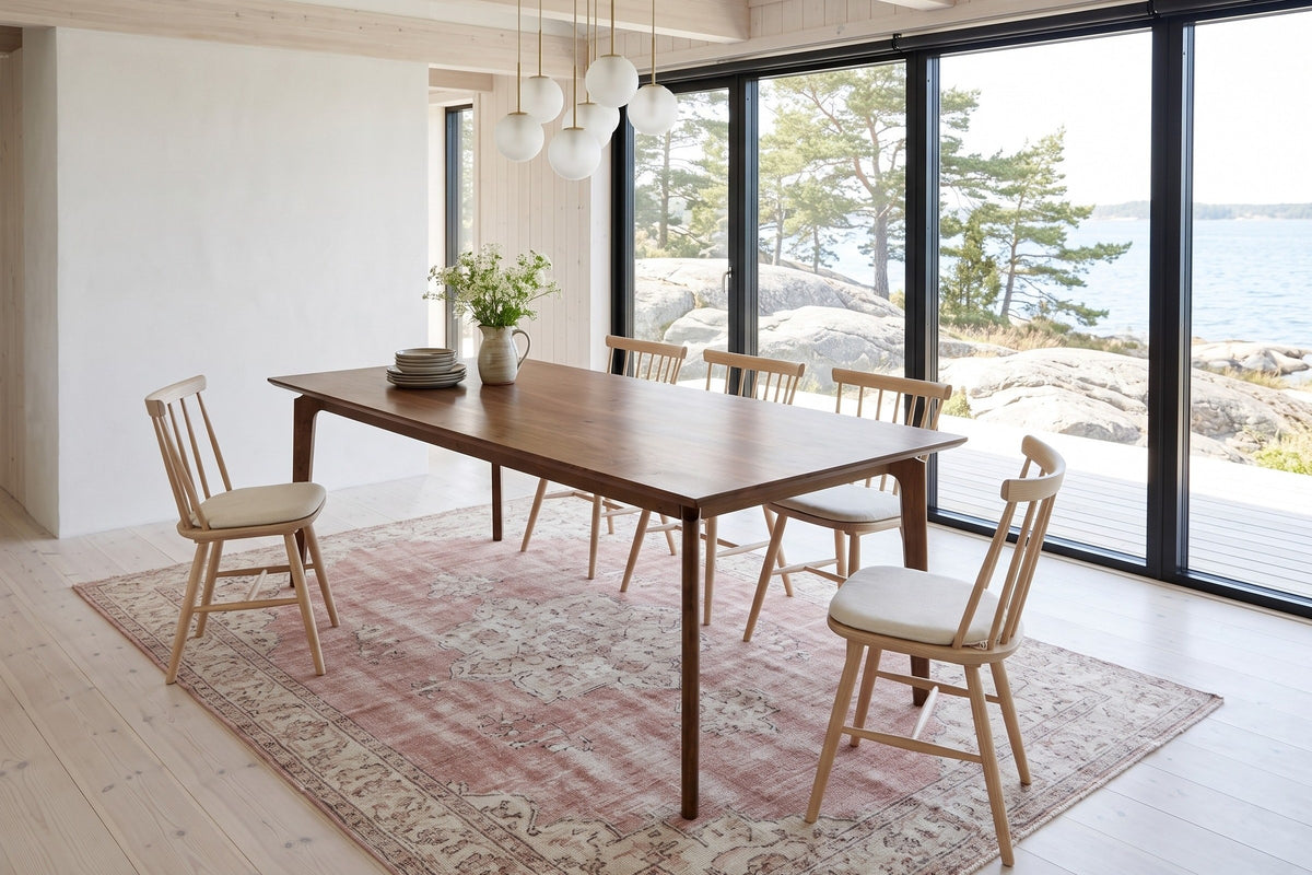 Calascio dining table in Brown seen from above in a Stockholm archipelago summer house, with white pine walls