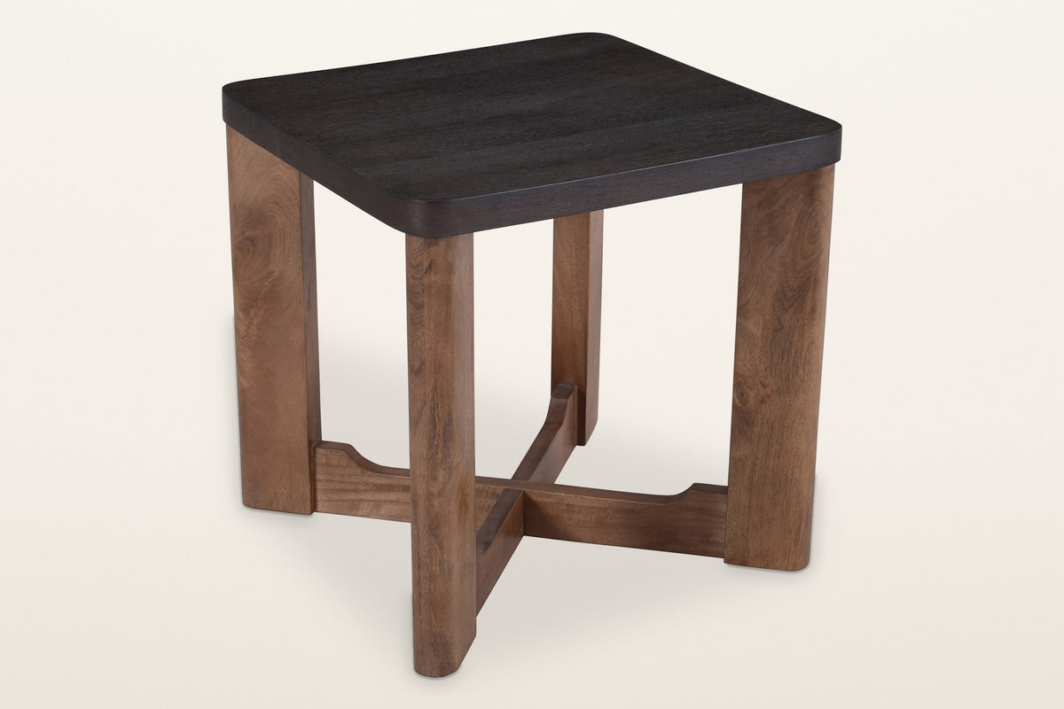 Calcata two-tone mango wood side table, a mocha top on a walnut base, three-quarter view on a warm white studio backdrop