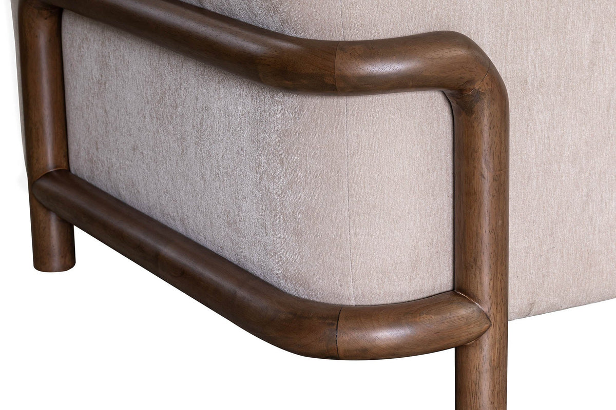 Close-up of the Calista rounded rubberwood frame wrapping the Sand fabric arm