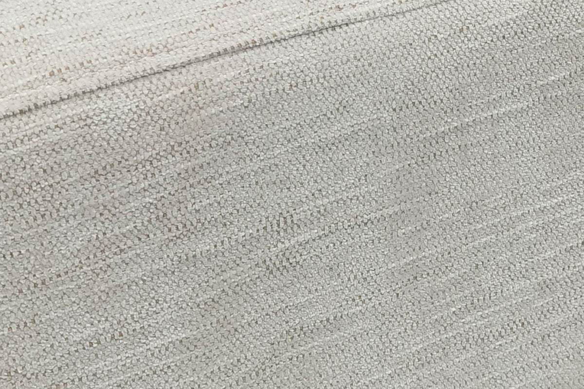 Close-up of the Caltagirone seat in Oatmeal Sand: a pale slub weave and the welt along the top edge