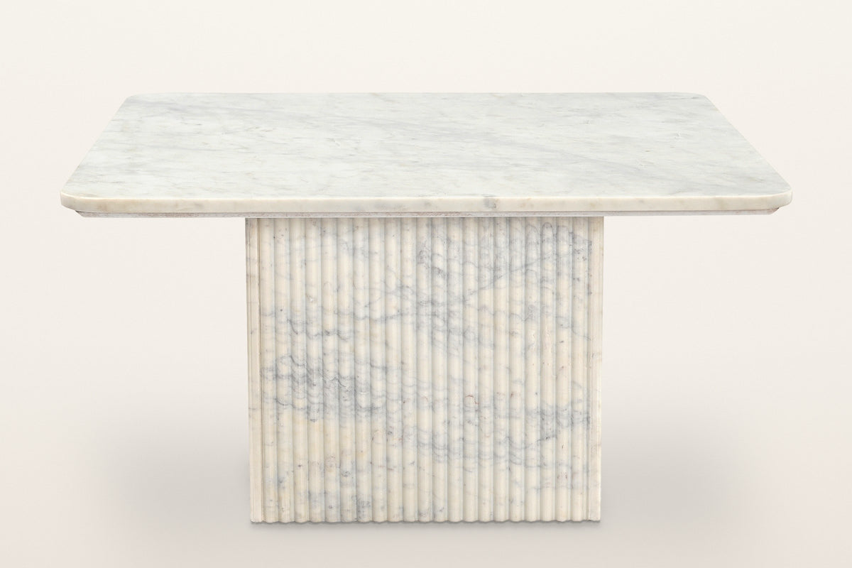 Campiglia coffee table seen from the front: a thin square marble top on one reeded marble pedestal