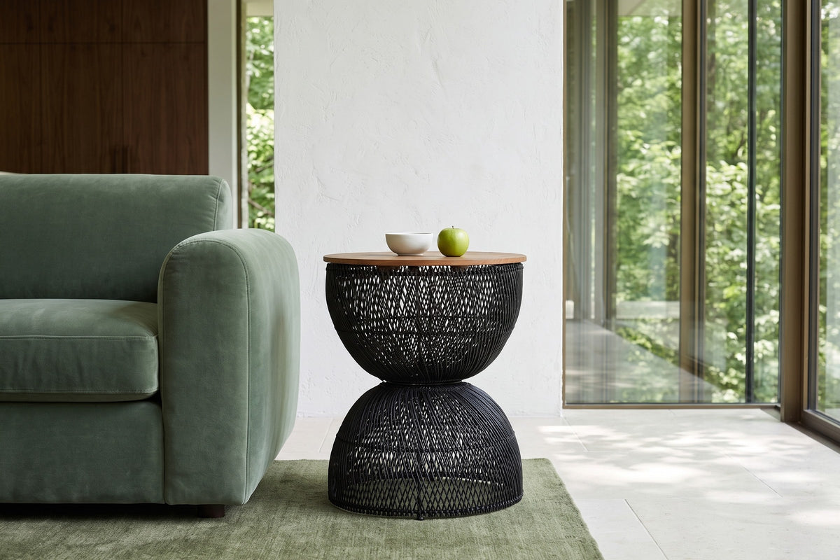 Side view of the Canale side table in Black beside a sage velvet sofa in a London, Ontario house above the Thames ravine