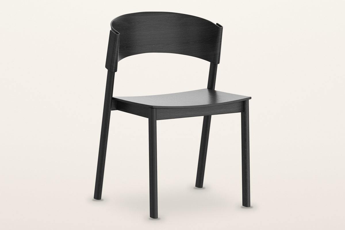 Canelli oak dining chair in black, three-quarter view on a warm white studio backdrop