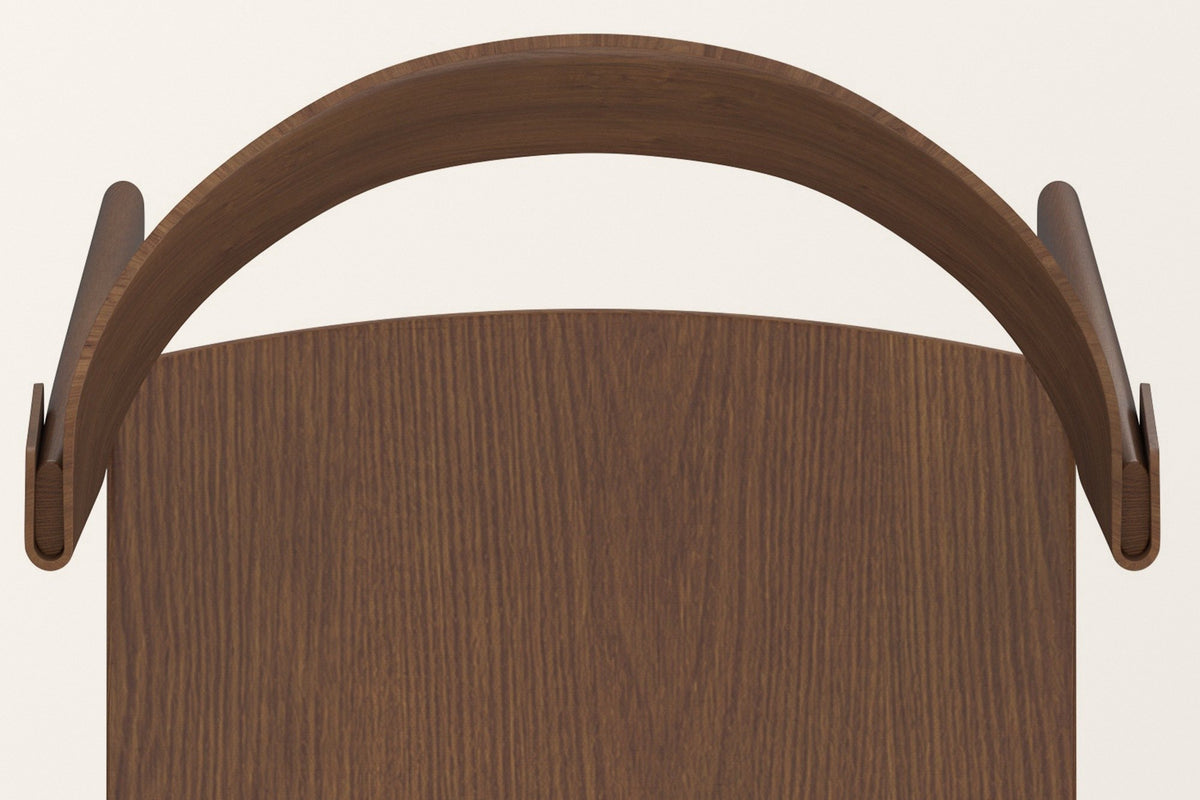 The Canelli chair in walnut seen from above: the half-round back band, its two folded ends and the oak grain of the seat