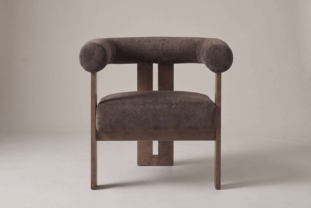 Caorle accent chair in dark brown velvet, straight front view: one round tube for the back and arms, three flat birch legs