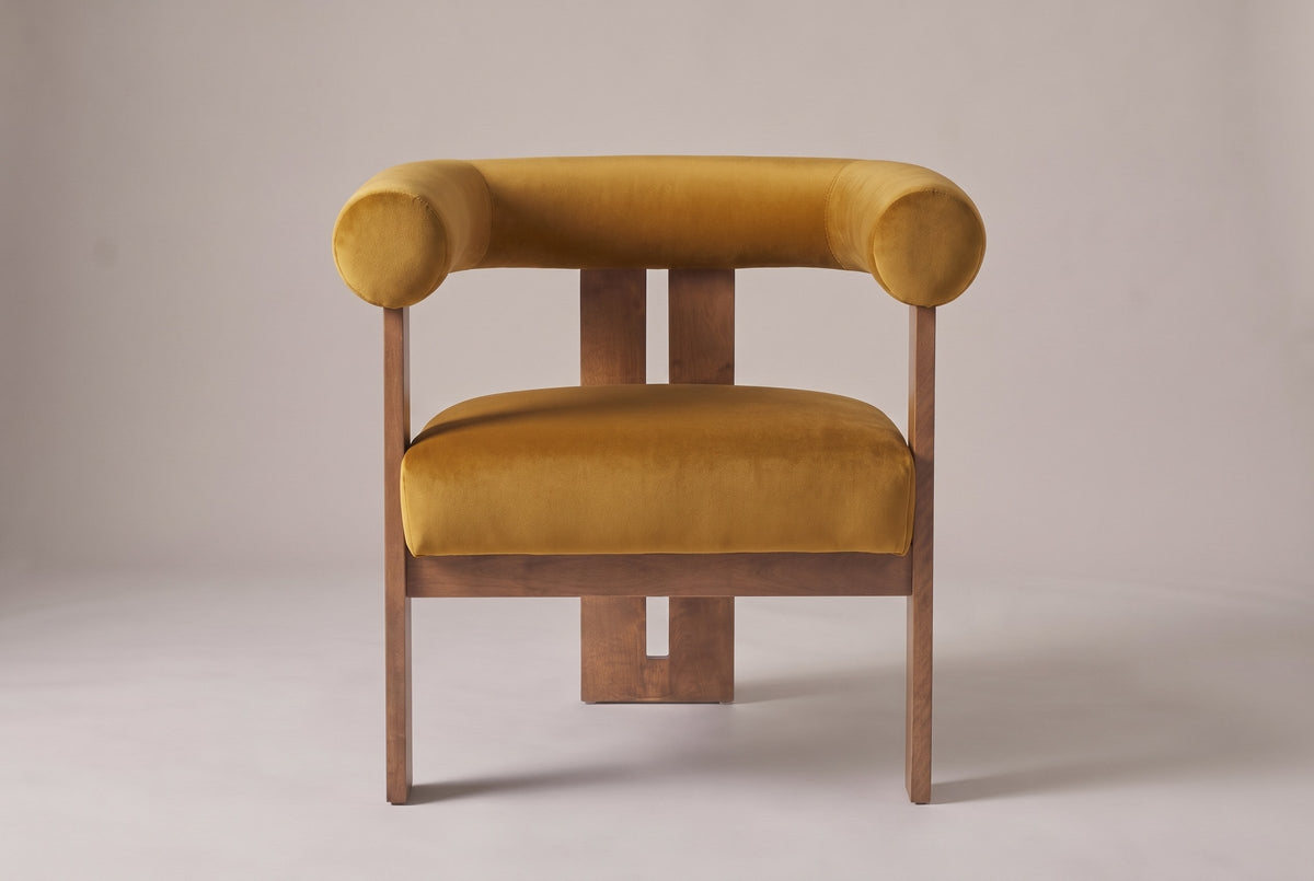 Caorle accent chair in mustard yellow velvet, straight front view: one round tube for the back and arms