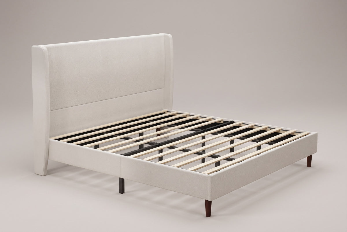 Carrara wingback bed in beige chenille, three-quarter view of the bare frame with wood slats on tapered wood legs