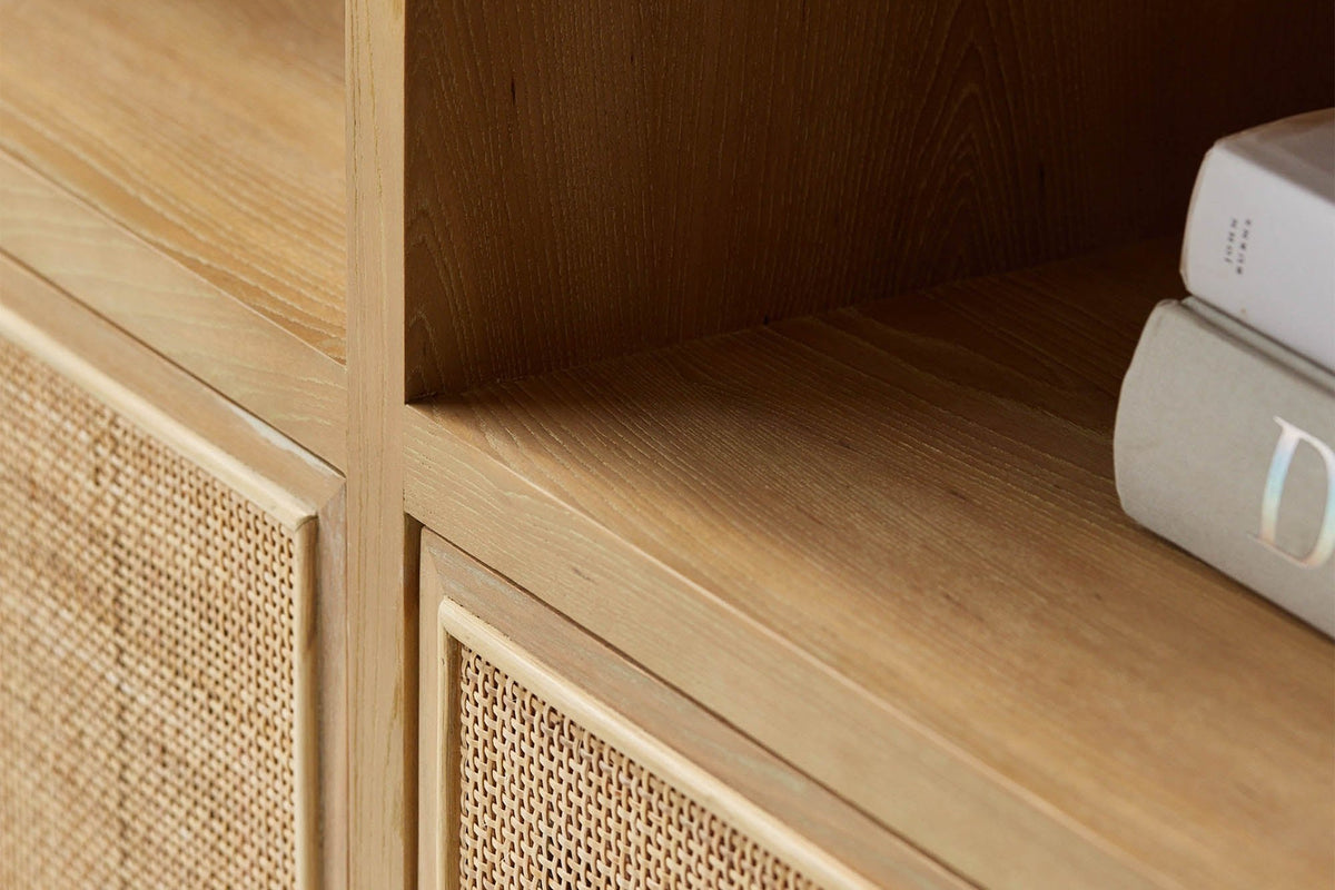 Close-up of Carver natural wood shelf and rattan door panel